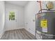 The utility room has a tank water heater and an exterior door at 1016 Confederate S Ave, Rock Hill, SC 29732