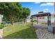 Green backyard featuring a gazebo, storage shed, and white privacy fence at 112 Artisan Ct, Mooresville, NC 28117