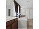 Bright bathroom featuring a soaking tub, double vanity, and neutral tile flooring at 112 Artisan Ct, Mooresville, NC 28117
