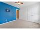 Bedroom with vibrant blue accent wall and ample closet space at 112 Artisan Ct, Mooresville, NC 28117