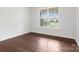 Serene bedroom with hardwood floors and a large window offering natural light at 112 Artisan Ct, Mooresville, NC 28117