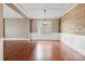 Spacious dining room with hardwood floors, shiplap accent wall, wainscoting, and elegant chandelier at 112 Artisan Ct, Mooresville, NC 28117