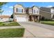 Attractive two-story home with an inviting front porch and long driveway leading to a two-car garage at 112 Artisan Ct, Mooresville, NC 28117