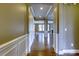Inviting hallway with wainscoting, hardwood floors, and views of the open-concept layout at 112 Artisan Ct, Mooresville, NC 28117