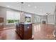 Modern kitchen with an island, granite countertops, stainless steel appliances, and hardwood floors at 112 Artisan Ct, Mooresville, NC 28117