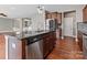 Modern kitchen with stainless steel appliances, granite countertops, and dark wood cabinetry at 112 Artisan Ct, Mooresville, NC 28117