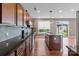 Open kitchen with stainless steel appliances, dark countertops and view to the back yard at 112 Artisan Ct, Mooresville, NC 28117