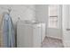 The laundry room includes modern washer and dryer with overhead shelving at 112 Artisan Ct, Mooresville, NC 28117