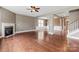 Bright living room with hardwood floors, a fireplace, and staircase leading to the upper level at 112 Artisan Ct, Mooresville, NC 28117
