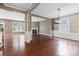 Open-concept living room featuring hardwood floors, a fireplace, and coffered ceilings at 112 Artisan Ct, Mooresville, NC 28117