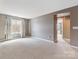 Spacious living room with neutral walls, lots of light and a carpeted floor at 112 Artisan Ct, Mooresville, NC 28117