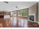 Spacious living area featuring an open kitchen, fireplace, and hardwood flooring at 112 Artisan Ct, Mooresville, NC 28117