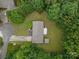 Aerial view of the home showing a well-maintained yard, back porch, and surrounding trees at 1142 Foxberry Rd, Lincolnton, NC 28092