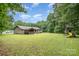 A large private backyard features a wood shed and playset, perfect for outdoor enjoyment at 1142 Foxberry Rd, Lincolnton, NC 28092