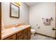 Bathroom with sink and vanity with wood cabinets, mirror, toilet, and towel racks at 1142 Foxberry Rd, Lincolnton, NC 28092