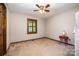 Bright bedroom featuring ceiling fan, carpet floors, and window with wooden blinds at 1142 Foxberry Rd, Lincolnton, NC 28092