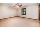 Bedroom featuring a ceiling fan, neutral carpet, and window with wooden shutters at 1142 Foxberry Rd, Lincolnton, NC 28092