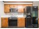 Kitchen features wood cabinets and appliances including microwave and refrigerator with ice maker at 1142 Foxberry Rd, Lincolnton, NC 28092