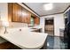 The kitchen has lots of storage with wood cabinets, a window, and a breakfast bar at 1142 Foxberry Rd, Lincolnton, NC 28092