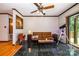 Well lit living room featuring a ceiling fan, telescope, and a sliding door to the deck at 1142 Foxberry Rd, Lincolnton, NC 28092