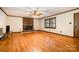 Bright living room featuring hardwood flooring and a cozy fireplace with brick surround at 1142 Foxberry Rd, Lincolnton, NC 28092