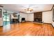 Open-concept living room showing wood floors, fireplace, and a glimpse of the kitchen with counter seating at 1142 Foxberry Rd, Lincolnton, NC 28092