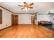 Living room showcasing hardwood floors, neutral walls with wood trim, with the kitchen through an archway at 1142 Foxberry Rd, Lincolnton, NC 28092