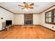 Spacious living room features hardwood floors, a brick fireplace, and neutral walls with wood trim at 1142 Foxberry Rd, Lincolnton, NC 28092