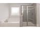 Bright bathroom featuring a soaking tub and separate glass-enclosed shower at 115 Kerr Walk Dr # 37, Statesville, NC 28677