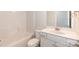 Bright bathroom featuring a tub/shower combo and vanity with white cabinets and marble countertops at 115 Kerr Walk Dr # 37, Statesville, NC 28677