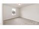 Bright bedroom features neutral walls, carpet flooring, and a window offering natural light at 115 Kerr Walk Dr # 37, Statesville, NC 28677