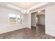 Inviting dining room featuring dark wood floors, a chandelier, and plenty of natural light at 115 Kerr Walk Dr # 37, Statesville, NC 28677