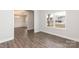 Welcoming entryway featuring dark wood flooring and views of the dining room and front windows at 115 Kerr Walk Dr # 37, Statesville, NC 28677