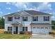 Charming two-story home with gray siding, black shutters and an attached two car garage at 115 Kerr Walk Dr # 37, Statesville, NC 28677