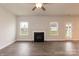 Cozy living room with a fireplace, wood floors, and plenty of natural light from the windows at 115 Kerr Walk Dr # 37, Statesville, NC 28677