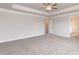 Bright main bedroom with neutral walls, carpet, and tray ceiling at 115 Kerr Walk Dr # 37, Statesville, NC 28677