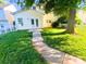 A quaint backyard with a healthy lawn, a white picket fence, and a concrete walk leading to the back door at 11624 Truan Ln, Cornelius, NC 28031