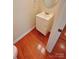 Bright half bathroom featuring wooden floors, a modern vanity, and fresh paint, conveniently located near the main living areas at 11624 Truan Ln, Cornelius, NC 28031
