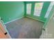 Bright bedroom with two windows, neutral carpet, and a fresh green paint that creates a relaxing atmosphere at 11624 Truan Ln, Cornelius, NC 28031