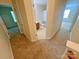 Open hallway connecting to a full bathroom, bedroom, and living space, with modern neutral carpet throughout at 11624 Truan Ln, Cornelius, NC 28031