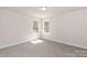 The simple yet elegant bedroom features a plush carpet, natural light from two windows and neutral paint at 118 Kerr Walk Dr # 17, Statesville, NC 28677