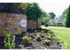 Inviting entrance to the Northlake community, featuring a stone wall, lush landscaping, and a glimpse of a home at 118 Kerr Walk Dr # 17, Statesville, NC 28677