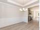 The dining room features stylish flooring, wainscoting, a modern chandelier, and views into the kitchen at 118 Kerr Walk Dr # 17, Statesville, NC 28677