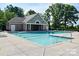 Community pool featuring a covered pavilion, accessible with a modern concrete deck and metal railing at 118 Kerr Walk Dr # 17, Statesville, NC 28677