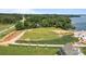 Beautiful aerial view of a large lot with a lake in the background and a tree lined street at 14515 Nc Hwy 73 Hwy, Huntersville, NC 28078