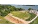 Lakefront lot with partial lawn, newly planted trees, and driveway, offering stunning water views at 14515 Nc Hwy 73 Hwy, Huntersville, NC 28078