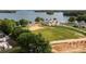 Stunning aerial shot of an estate on a lakefront lot, featuring a sprawling lawn and mature trees at 14515 Nc Hwy 73 Hwy, Huntersville, NC 28078