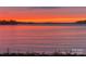 Scenic sunset view over the lake, featuring vibrant orange and red hues reflecting on the calm water at 14515 Nc Hwy 73 Hwy, Huntersville, NC 28078
