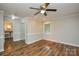 Large bedroom with hardwood floors, neutral walls, ceiling fan, closet, and view to bath at 1506 Cameron Dr, Statesville, NC 28625