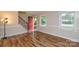 Bright living room with hardwood floors and an open staircase at 1506 Cameron Dr, Statesville, NC 28625